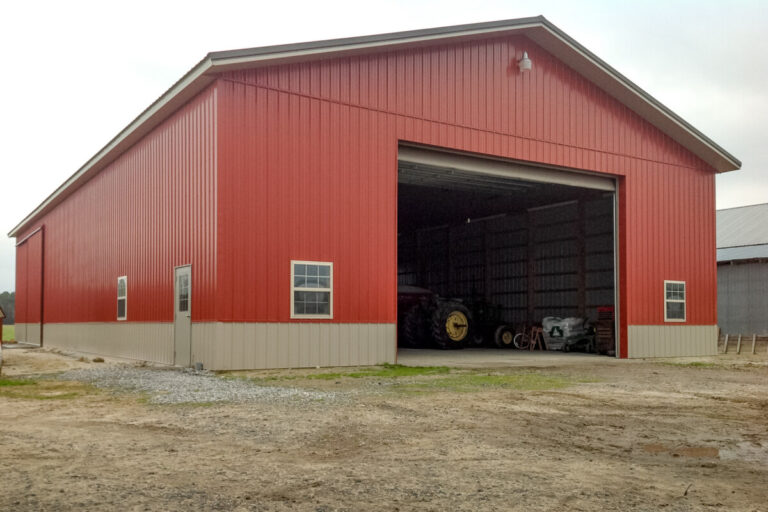 large implement shed with red siding