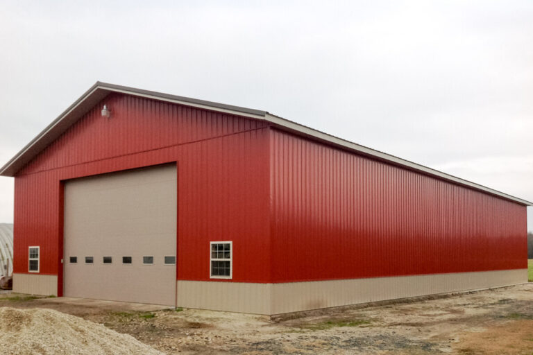 large implement shed with red siding
