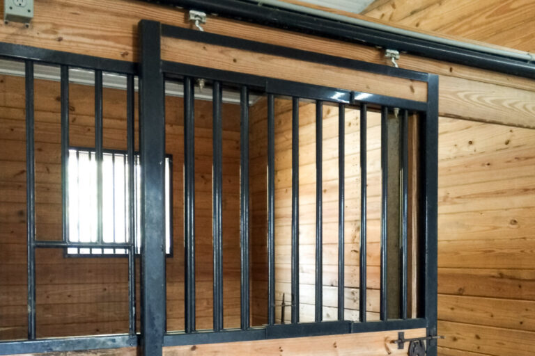 Horse stall with black iron bars